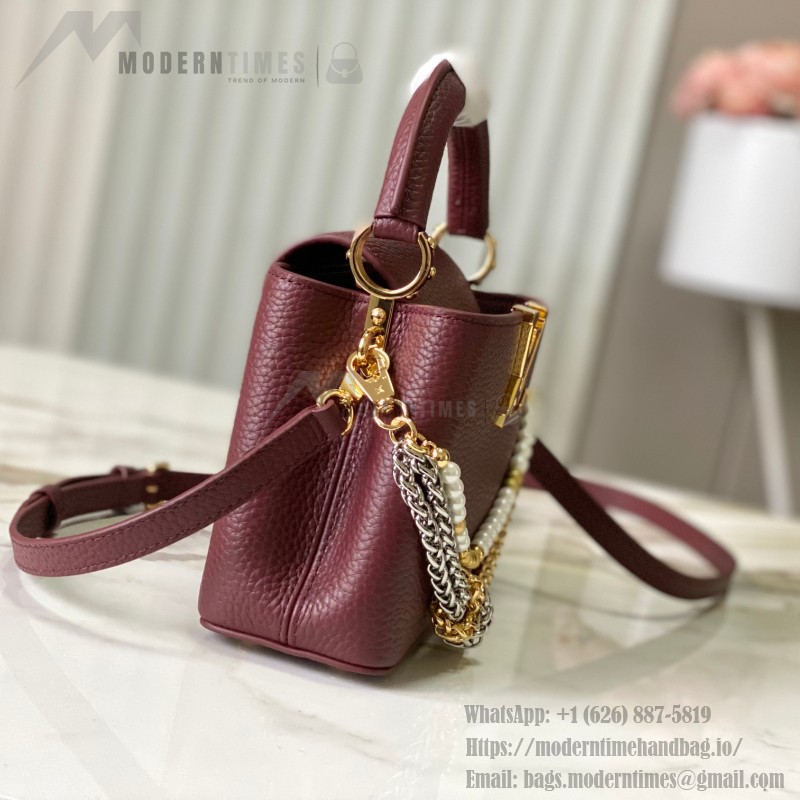 Louis Vuitton Capucines East-West Why Knot Taurillon leather handbag in mini and small sizes with Monogram beaded chain and shiny metal hardware