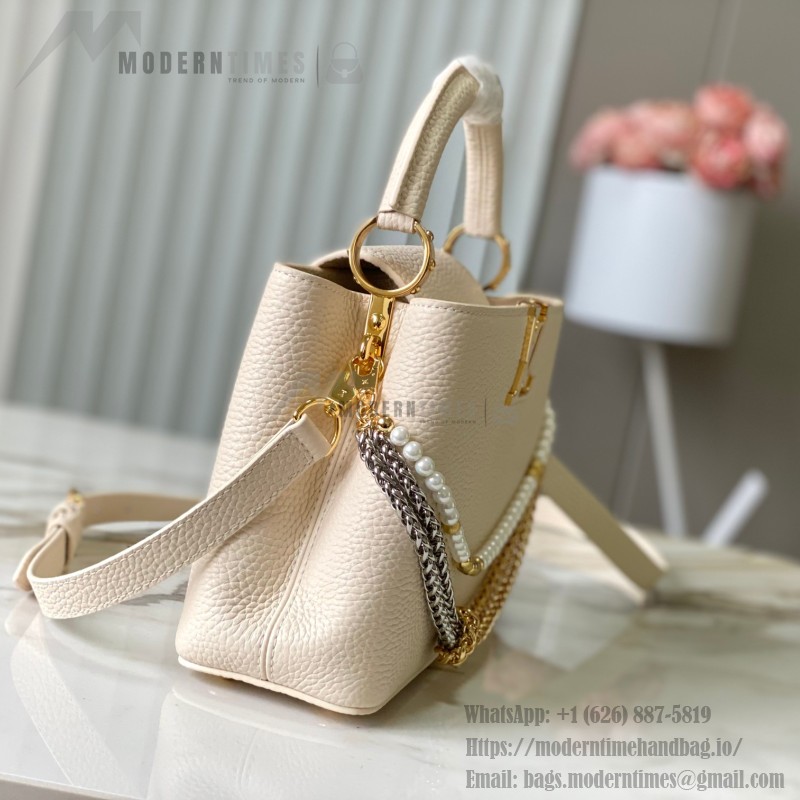Louis Vuitton Capucines East-West Why Knot Taurillon leather handbag in mini and small sizes with Monogram beaded chain and shiny metal hardware