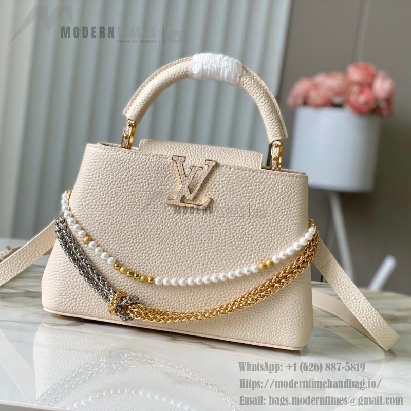 Louis Vuitton Capucines East-West Why Knot Taurillon leather handbag in mini and small sizes with Monogram beaded chain and shiny metal hardware