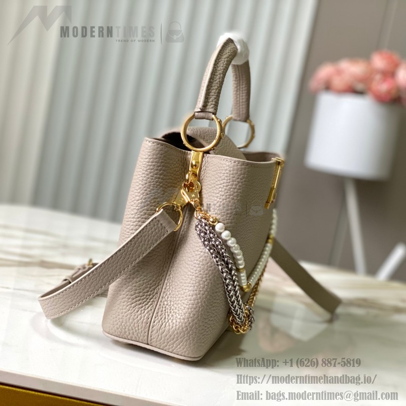 Louis Vuitton Capucines East-West Why Knot Taurillon leather handbag in mini and small sizes with Monogram beaded chain and shiny metal hardware