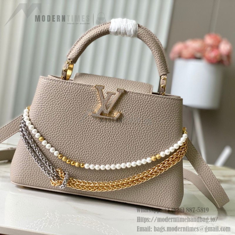 Louis Vuitton Capucines East-West Why Knot Taurillon leather handbag in mini and small sizes with Monogram beaded chain and shiny metal hardware