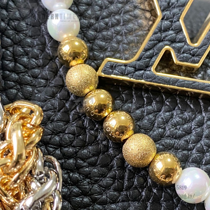 Louis Vuitton Capucines East-West Why Knot Taurillon leather handbag in mini and small sizes with Monogram beaded chain and shiny metal hardware