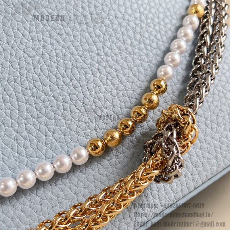 Louis Vuitton Capucines East-West Why Knot Taurillon leather handbag in mini and small sizes with Monogram beaded chain and shiny metal hardware