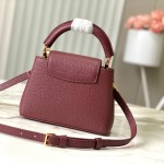 Louis Vuitton Capucines East-West Why Knot Taurillon leather handbag in mini and small sizes with Monogram beaded chain and shiny metal hardware