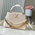 Louis Vuitton Capucines East-West Why Knot Taurillon leather handbag in mini and small sizes with Monogram beaded chain and shiny metal hardware