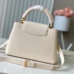 Louis Vuitton Capucines East-West Why Knot Taurillon leather handbag in mini and small sizes with Monogram beaded chain and shiny metal hardware