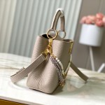 Louis Vuitton Capucines East-West Why Knot Taurillon leather handbag in mini and small sizes with Monogram beaded chain and shiny metal hardware