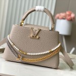 Louis Vuitton Capucines East-West Why Knot Taurillon leather handbag in mini and small sizes with Monogram beaded chain and shiny metal hardware