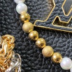 Louis Vuitton Capucines East-West Why Knot Taurillon leather handbag in mini and small sizes with Monogram beaded chain and shiny metal hardware