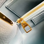 Louis Vuitton Capucines East-West Why Knot Taurillon leather handbag in mini and small sizes with Monogram beaded chain and shiny metal hardware
