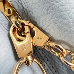 Louis Vuitton Capucines East-West Why Knot Taurillon leather handbag in mini and small sizes with Monogram beaded chain and shiny metal hardware