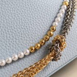 Louis Vuitton Capucines East-West Why Knot Taurillon leather handbag in mini and small sizes with Monogram beaded chain and shiny metal hardware